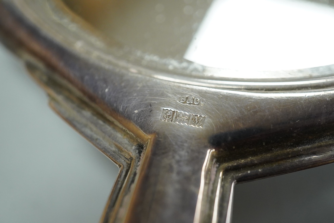 An Elizabeth II engine turned silver Art Deco style four pieced dressing table mirror, brush and comb set, W.I. Broadway & Co, Birmingham, 1961/63/65, mirror 27.8cm.